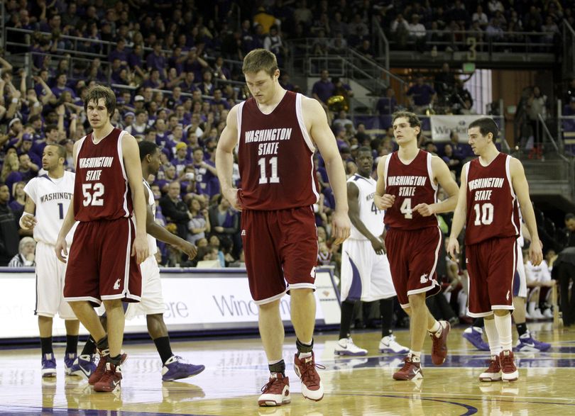 WSU's Caleb Forrest (52), Aron Baynes (11), Nikola Koprivica (4), and Taylor Rochestie (10) walk down the court after a break in the action against Washington in the final minutes of the game. (Ted Warren / Associated Press)