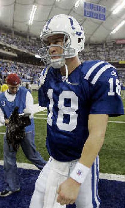 
Peyton Manning walks off the field. 
 (Associated Press / The Spokesman-Review)