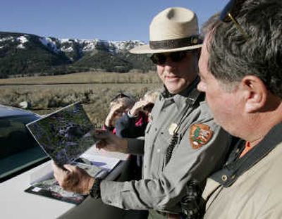 
Seasonal ranger John Kerr shows pictures of bears to tourists in Yellowstone National Park, Wyo.
 (Associated Press / The Spokesman-Review)