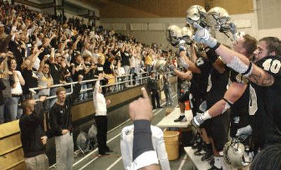 
Idaho Vandals players celebrate with fans after defeating Idaho State on Saturday in Moscow.
 (Associated Press / The Spokesman-Review)