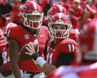 In this Sept. 1, 2018, file photo, Georgia quarterback Jake Fromm (11) warms up as quarterback Justin Fields looks on before an NCAA college football game against Austin Peay, in Athens, Ga. Fromm is Georgia's starting quarterback. There is no question about that. How much playing time, if any, does that leave for touted freshman Justin Fields? (Curtis Compton / Atlanta Journal-Constitution via AP)