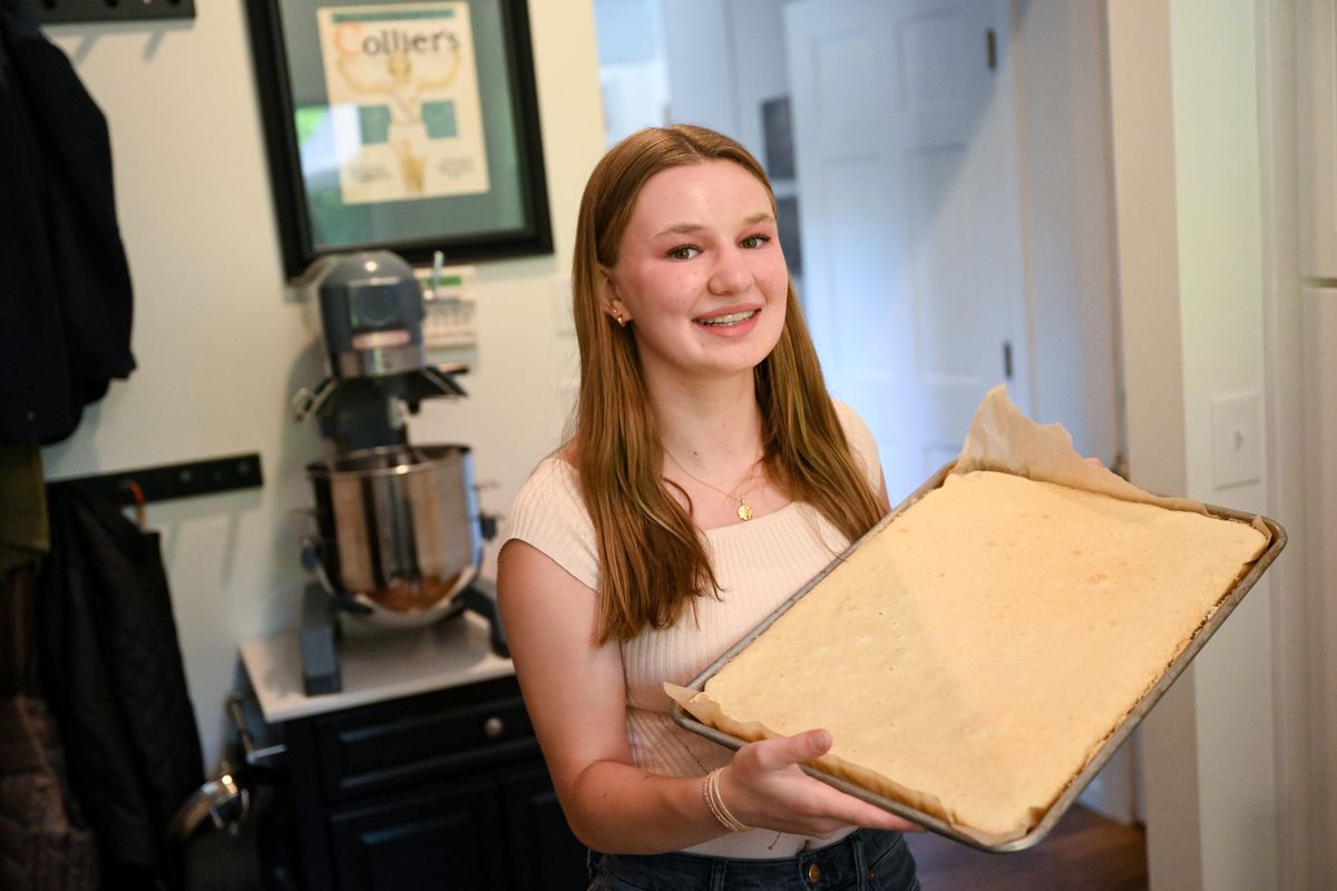 Baker Madison Stoltz, 15, who runs Snak Rabbit, poses for a photo earlier this month with a cake that she would use to make cake pops.  (Tyler Tjomsland/The Spokesman-Review)