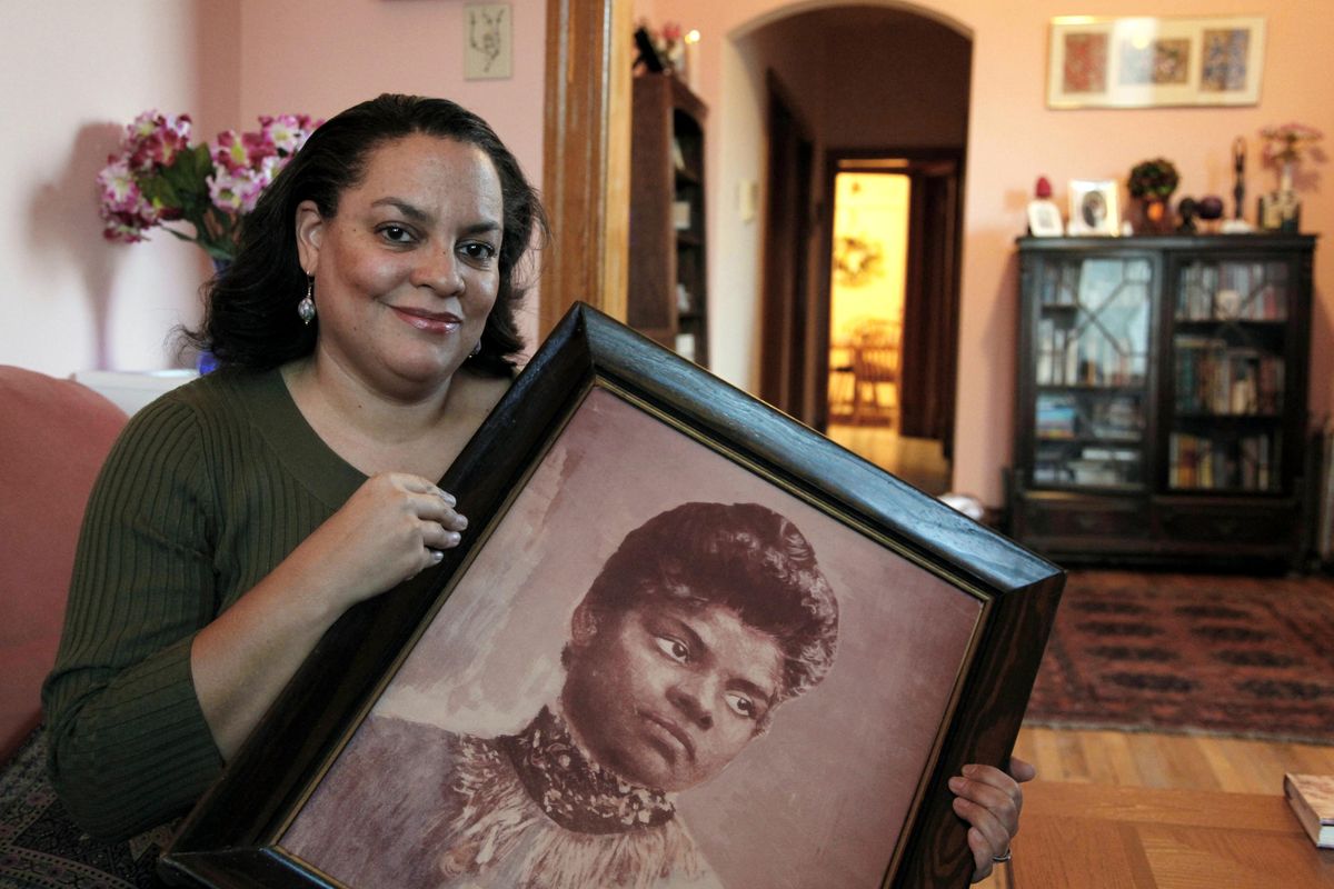 In this Dec. 2, 2011 file photo, Michelle Duster, great-granddaughter of civil rights pioneer Ida B. Wells who led a crusade against lynching during the early 20th century, holds a portrait of Wells in her home in Chicago’s South Side. Historically, black women have been no strangers to the quest for social change. But historians say they have often been overshadowed, first by white women during the suffragette movement and then by the black men who were lionized during the civil rights movement. A new generation of black women is now moving to take and keep a place at the forefront of the fight against racial bias. (Charles Rex Arbogast / Associated Press)