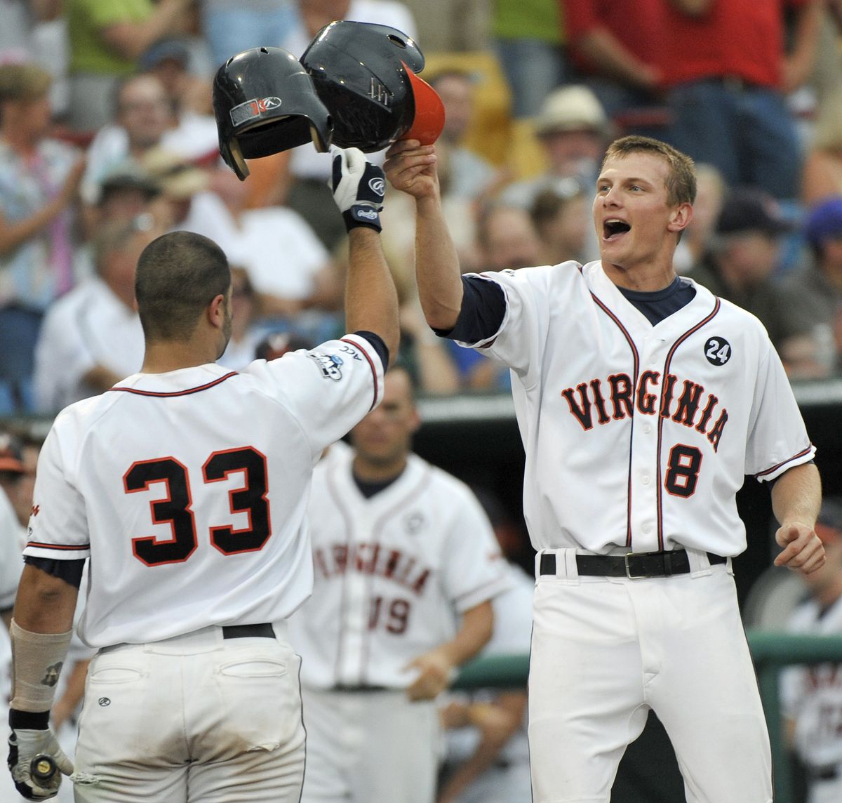 Virginia’s John Hicks, right, celebrates after hitting a home run in the 2009 College World Series. (Associated Press)