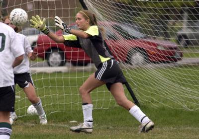 
East Valley High's Megan Como catches the ball during a game against North Central on Monday. Como's sister, Tiera, also played goalkeeper for EVHS and graduated in 2002. Tiera now plays for Eastern Washington University.
 (Liz Kishimoto / The Spokesman-Review)