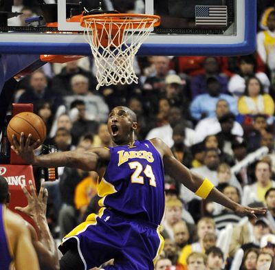 Lakers guard Kobe Bryant goes in reverse to the basket in Los Angeles’ 114-102 NBA win over host Philadelphia, Bryant’s hometown.  (Associated Press / The Spokesman-Review)