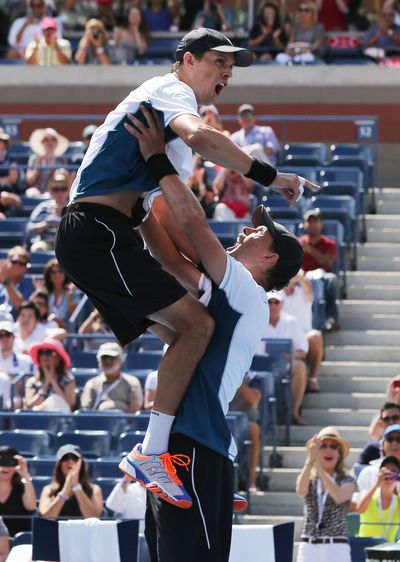 Bob Bryan, right, and brother Mike, don’t quite get their signature chest bump right. (Associated Press)