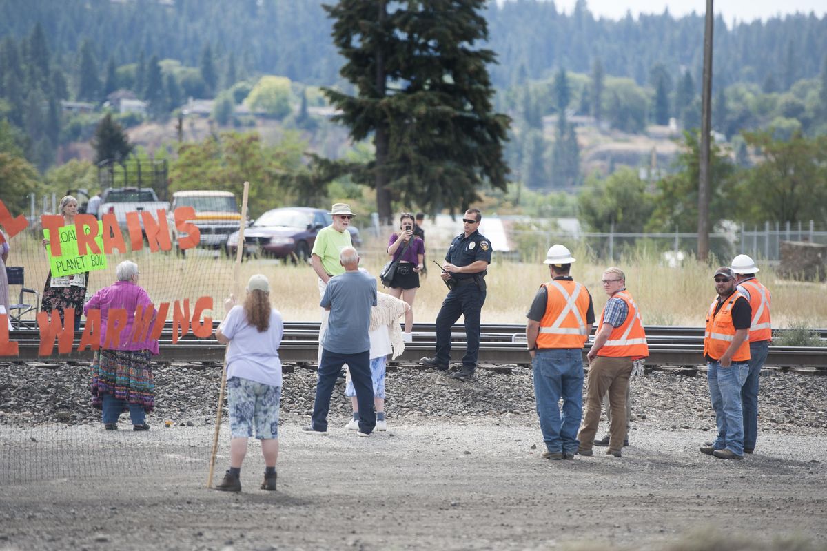 Protesters gather on railroad tracks near 2302 East Trent to protest the movement of oil and coal trains through Spokane on Wednesday, Aug. 31, 2016, in east Spokane, Wash. (Tyler Tjomsland / The Spokesman-Review)