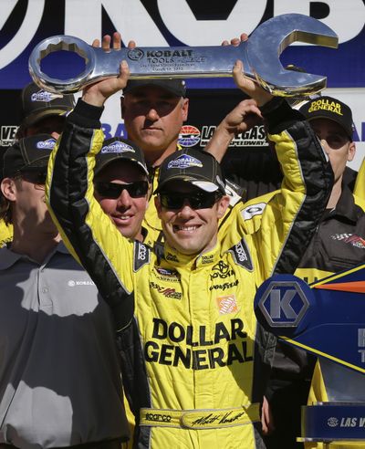 Matt Kenseth holds up the victor’s trophy after winning on Sunday. (Associated Press)