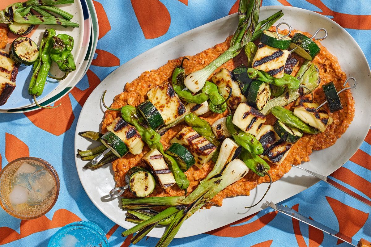 Halloumi Kebabs with Romesco are a great way to put spring onions to work. (Tom McCorkle; food styling by Gina Nistico/Both for The Washington Post)