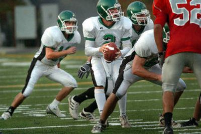
East Valley's Russell Woodworth looks for receivers during the second quarter of a 24-17 overtime loss to Ferris.
 (Holly Pickett / The Spokesman-Review)