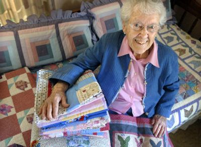 
Through the years, Olive Harrison, shown with baby quilts bound for Sacred Heart Medical Center, has made 1,200 quilts for the needy.  
 (Holly Pickett / The Spokesman-Review)