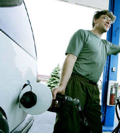 Mike Jorgenson fills up his '97 Chevy Blazer last week in Eagan, Minn., with regular fuel. Jorgenson said he could save big money if he had a flexible-fuel vehicle for his daily 130-mile round-trip commute to work.
(Associated Press / The Spokesman-Review)
