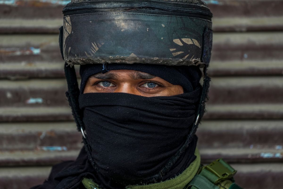 An Indian soldier guards at the site of a grenade explosion Sunday in Srinagar, Kashmir. (Mukhtar Khan)