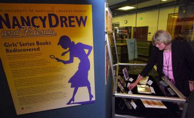 
Ann L. Hudak, assistant curator at the University of Maryland library, stands amid the new exhibit 