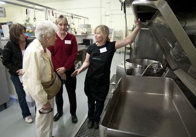 Senior meals chef Jerri Horton, far right, shows  visitors left to right, Jill Ryan, Meredith Elsensohn and Jayne Seabold the tilt griddle in the Valley Meals on Wheels new  kitchen.The Sposkesman-Review (COLIN MULVANY The Sposkesman-Review / The Spokesman-Review)