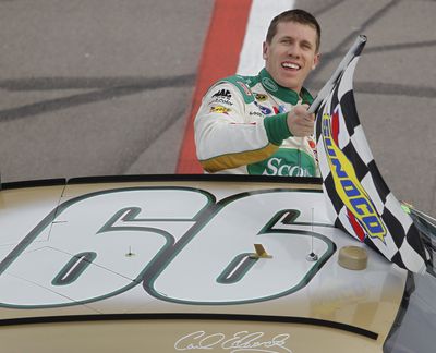 Carl Edwards holds the checkered flag after winning the NASCAR Sprint Cup Series race in Las Vegas. (Associated Press)
