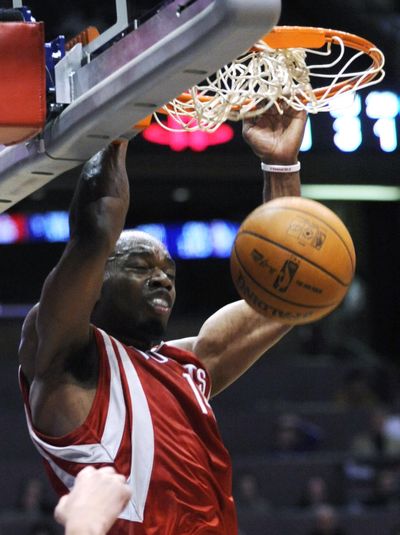 Carl Landry dunks during the fourth quarter of Houston’s win over New Jersey. Landry led all scorers with 26 points. (Associated Press)