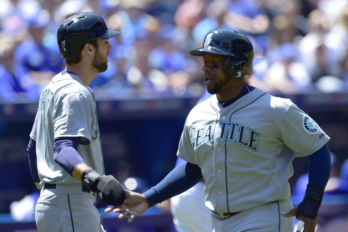 Mariners Chris Taylor, left, and Rickie Weeks scored in the third inning on Willie Bloomquist’s double. (Frank Gunn)