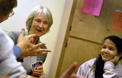 
Lorraine  Harmon, center, shares a moment with Cassie  Purvis, left, as Brittney Scott smiles along last Thursday during the Deaf and Hard of Hearing Social Club gathering at the Eastern Washington Center for the Deaf and Hard of Hearing.
 (Jed Conklin / The Spokesman-Review)