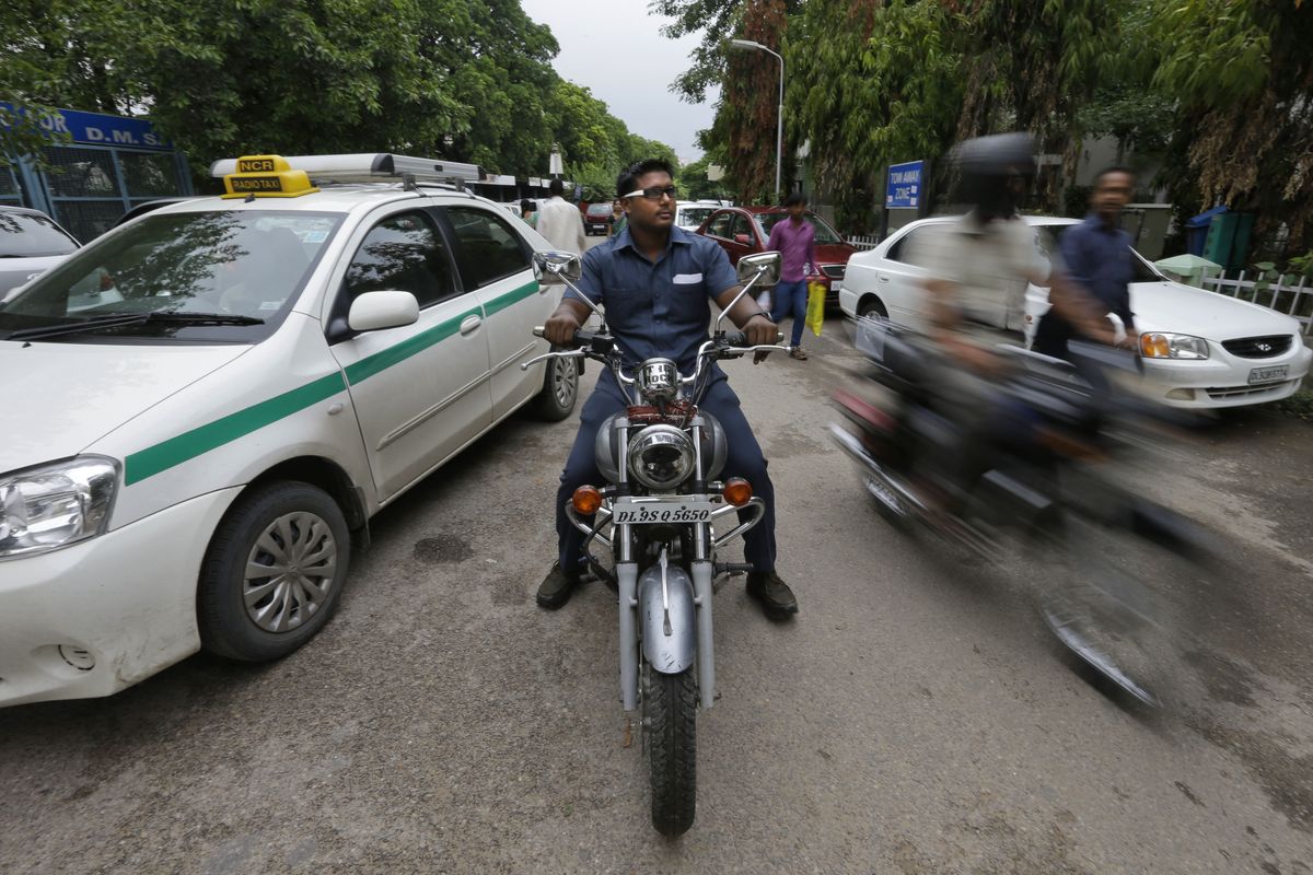 In this Tuesday, Aug. 21, 2012 photo, Pradeep Kumar rides his motorbike as he heads to work at the Deen Dayal Upadhyay Hospital in New Delhi, India.  Kumar and 20 other bouncers have been hired to protect doctors as well as keep the emergency and labor rooms from filling up with patients� often agitated relatives and friends. (Saurabh Das / Associated Press)