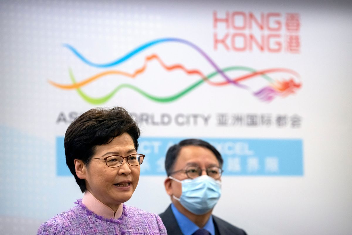 Hong Kong Chief Executive Carrie Lam, left, speaks as Eric Chan, director of the Chief Executive’s Office, listens during a press conference Wednesday in Beijing. (Mark Schiefelbein)