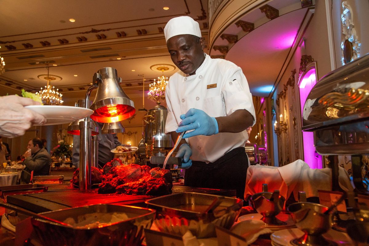Ibrahim Mohammed cuts beef at The Historic Davenport Hotel Champagne Sunday Brunch on Easter Sunday, April 21, 2019. Mohammed was in charge of lamb, ham and beef, and the hotel had 20 full prime ribs prepared. (Libby Kamrowski / The Spokesman-Review)
