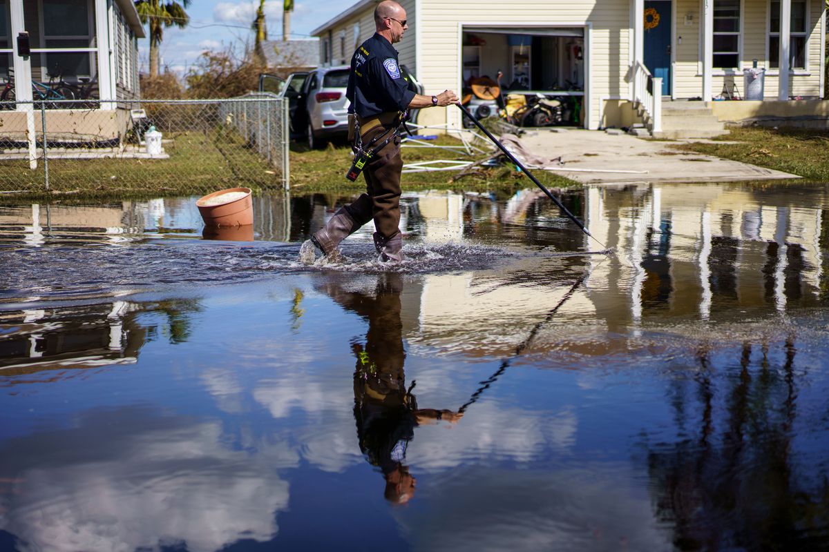 A search and rescue officer patrols a Harlem Heights neighborhood near Fort Myers Beach, Fla.  (Thomas Simonetti/For the Washington Post)