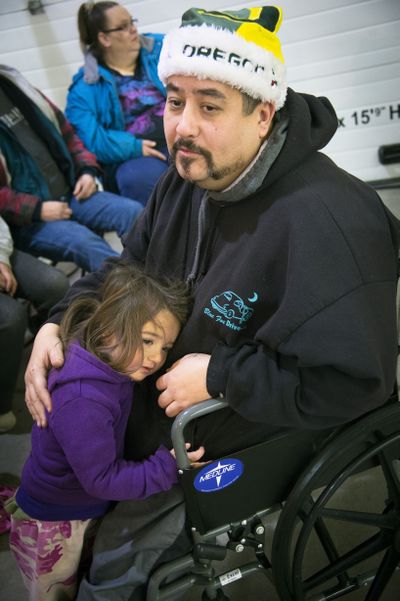 Dwaine Miller waits in line with his daughter Shandrea, 2, for the Christmas Bureau to open Thursday at the Spokane County Fair and Expo Center. “It would be pretty rough without the Christmas Bureau,” he said. (Colin Mulvany)