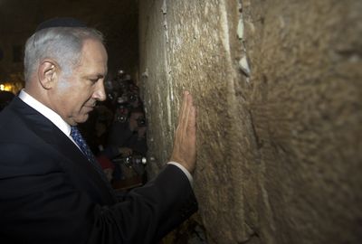 Likud Party leader Benjamin Netanyahu prays at the Western Wall in the Old City of Jerusalem on Monday.  (Associated Press / The Spokesman-Review)