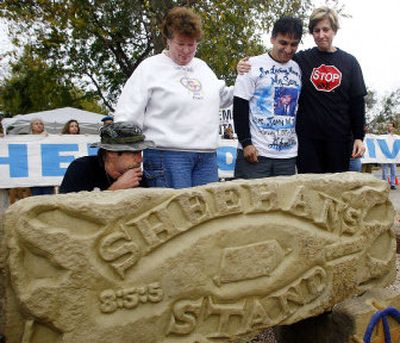
Peace activists Bill Mitchell, left, Dede Miller, Juan Torres and Cindy Sheehan look at a carved stone at the newly dedicated Camp Casey Memorial Garden on Friday in Crawford, Texas. 
 (Associated Press / The Spokesman-Review)