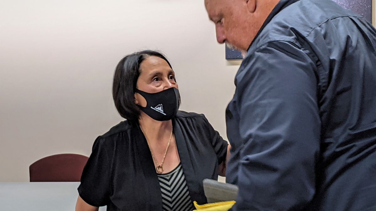 Lita Burns, acting president for North Idaho College, chats with Trustee Michael Barnes following a Board of Trustees meeting Friday, Sept. 24, 2021 in the college