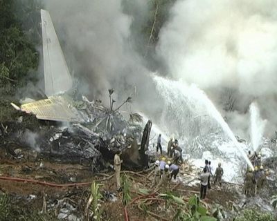 In this TV9 video, firefighters try to douse flames on an Air India plane that crashed in southern India   this morning after it overshot a runway while trying to land.  (Associated Press)