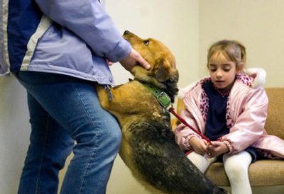 
Jaiden Anderson, 6, right, and her mother, Debra, spend a last few minutes with Buddy on Monday before he boards a plane from Spokane to Louisiana. 
 (Kathryn Stevens / The Spokesman-Review)