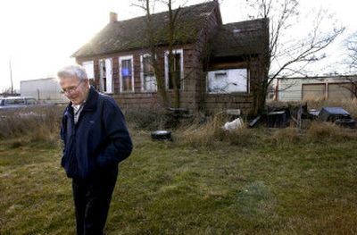 
Buell Hollister returns to his car after looking at the abandoned Lone Fir School in Spokane Valley. Hollister attended the one-room school  in the late 1930s and  has fond memories of his time spent there. 