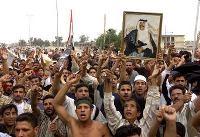 
Iraqis in Tikrit, a Sunni Arab stronghold and Saddam Hussein's hometown, protest his death sentence verdict on Sunday. 
 (Associated Press photos / The Spokesman-Review)