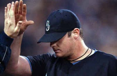 
Mariners starting pitcher Clint Nageotte sweats so much, he can go through three jerseys a game.
 (Associated Press / The Spokesman-Review)