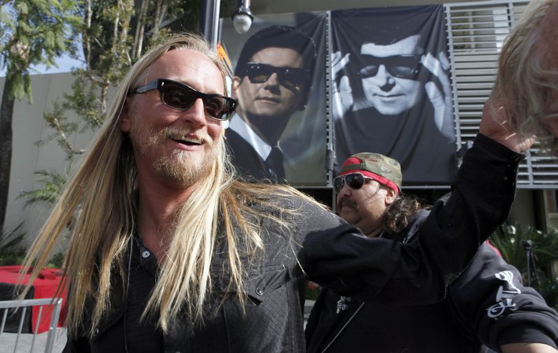 Alex Orbison speaks with fans in front of photographs of his father, the late rock and roll legend Roy Orbison during ceremonies honoring the elder Orbison with a star on the Hollywood Walk of Fame Friday Jan. 29, 2010 in Los Angeles. (Nick Ut / Associated Press)