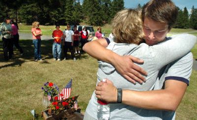
Michael Sippola hugs Karen Hattamer near her husband's grave Wednesday after finishing his fund-raiser walk from South Carolina to Spokane. Hattamer's husband died in Iraq.
 (Photos by Joe Barrentine/ / The Spokesman-Review)