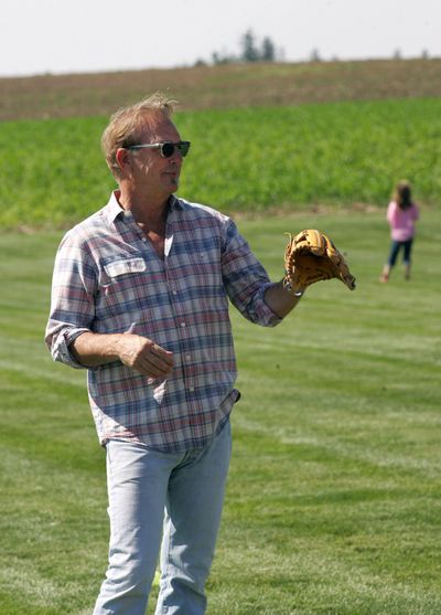 Kevin Costner plays catch Friday at a ball field near Dyersville, Iowa. (Associated Press)