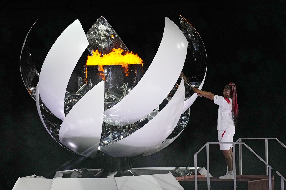 Naomi Osaka lights the Olympic flame during the opening ceremony in the Olympic Stadium at the 2020 Summer Olympics, Friday, July 23, 2021, in Tokyo, Japan.  (Associated Press)