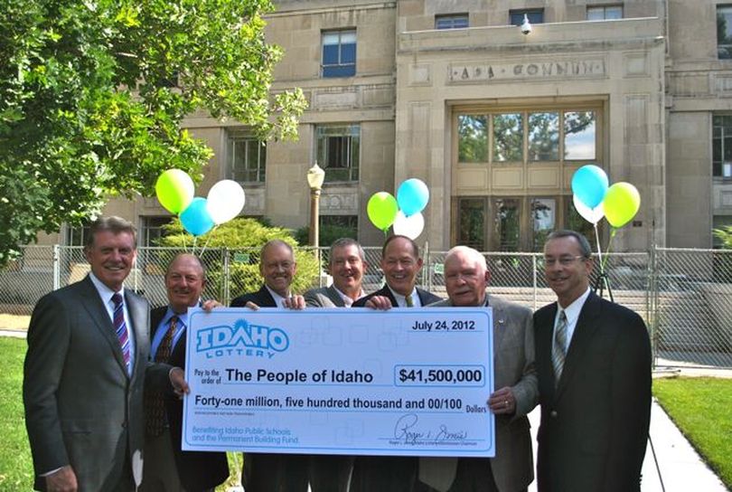 Gov. Butch Otter, left, receives a giant check representing the Idaho Lottery's record $41.5 million dividend this year; the money will be divided between schools and the state building fund. (Idaho Lottery)