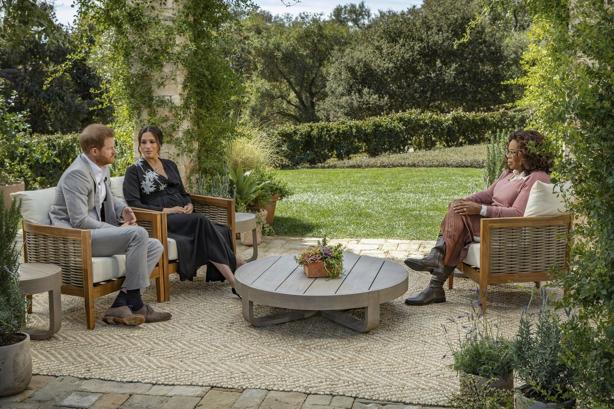 This image provided by Harpo Productions shows Prince Harry, from left, and Meghan, The Duchess of Sussex, in conversation with Oprah Winfrey.  (Joe Pugliese)