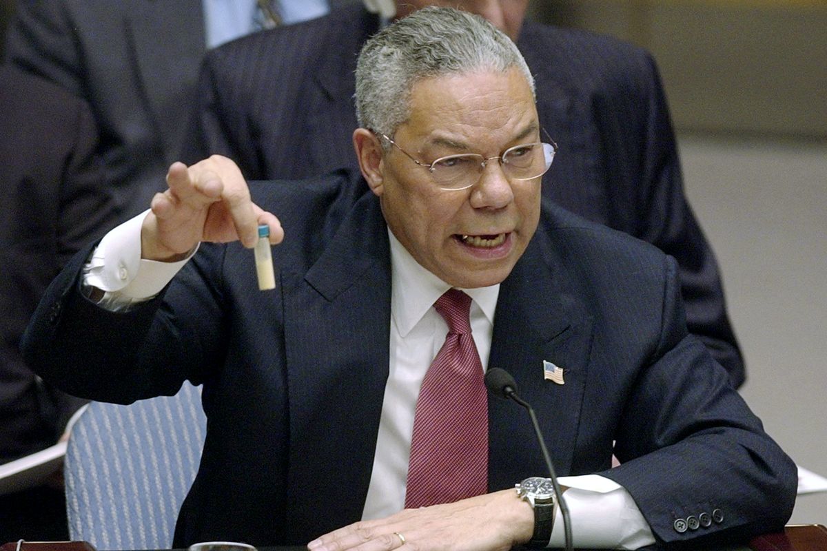 FILE - In this Feb. 5, 2003 file photo, Secretary of State Colin Powell holds up a vial he said could contain anthrax as he presents evidence of Iraq