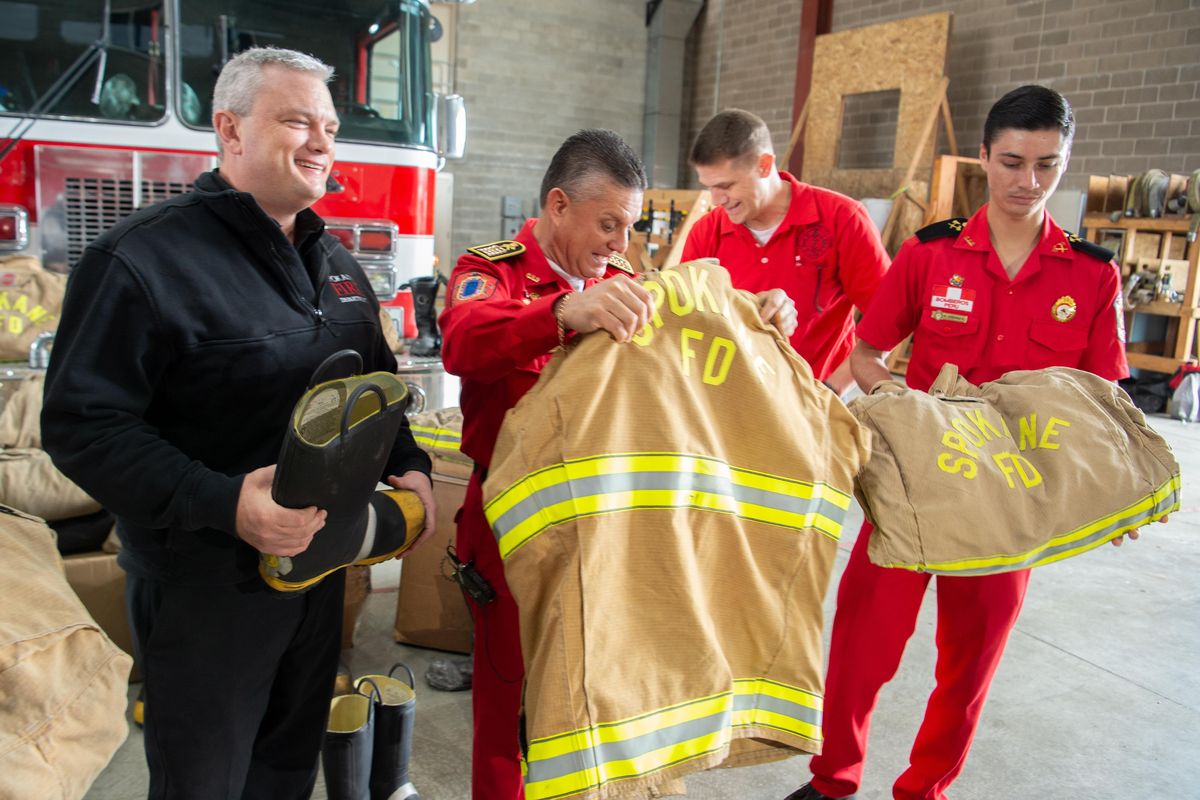 Spokane Fire Chief Brian Schaeffer, left, meets with Peruvian fire officials Jorge Gomez, center, and Kurt Loechle Duarte, right, to  announce a donation of turnout gear, which has been retired by use by Spokane Fire according to regulations, for the fire service in Peru, where all firefighters are volunteers and new equipment is hard to come by. The two fire service representatives were in Spokane to speak to a gathering of the state’s firefighters’ union. Eighteen years ago, state firefighter union officials went to Peru and creating professional contacts there through which other donations have been made. Standing behind the Peruvian officials is Tim Archer, president of the Firefighters Local 29. (Jesse Tinsley / The Spokesman-Review)