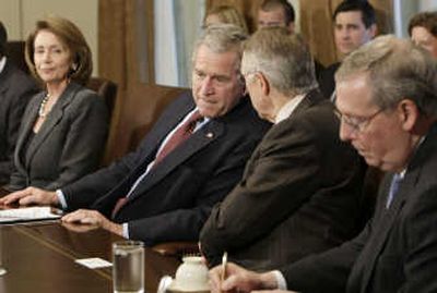 
President Bush confers with Senate Majority Leader Harry Reid, of Nevada, during a meeting Tuesday at the White House. Also on hand were House Speaker Nancy Pelosi, left, of California, and Senate Minority Leader Mitch McConnell, of Kentucky. Associated Press
 (Associated Press / The Spokesman-Review)