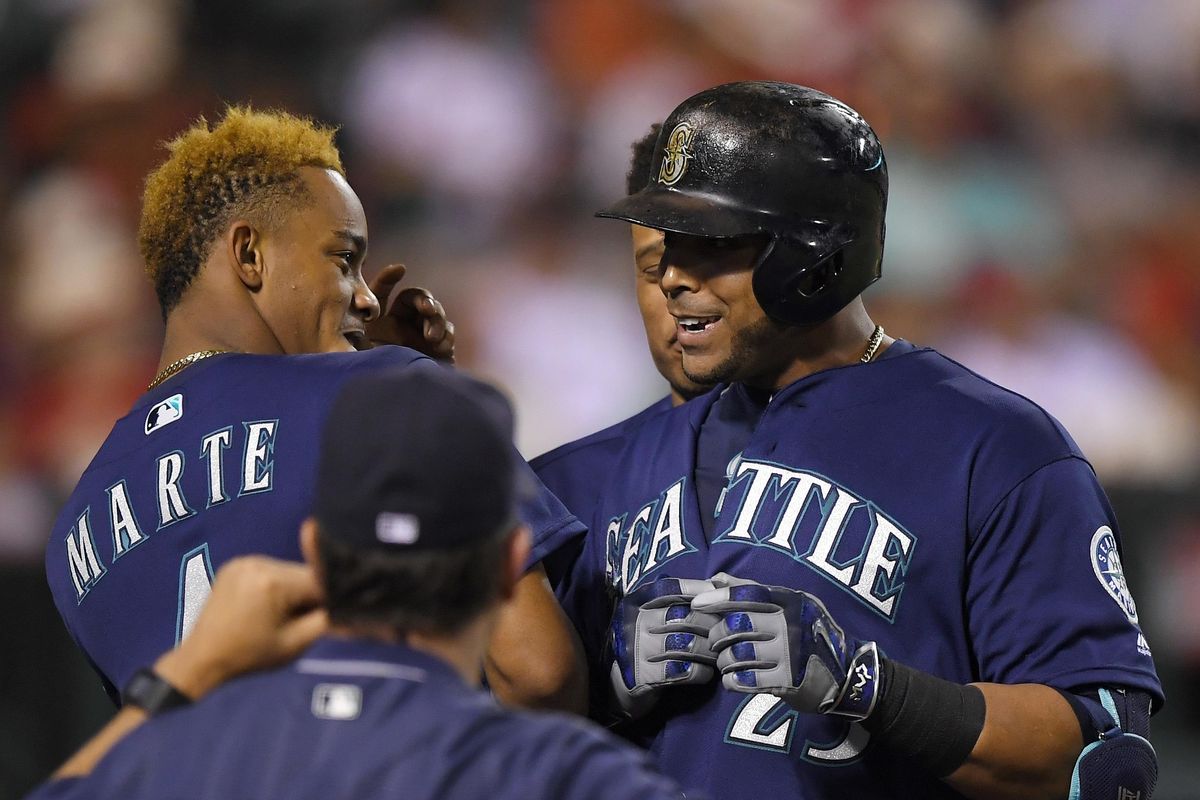 Nelson Cruz, right, brings the power to the Mariners lineup. (Mark J. Terrill / Associated Press)