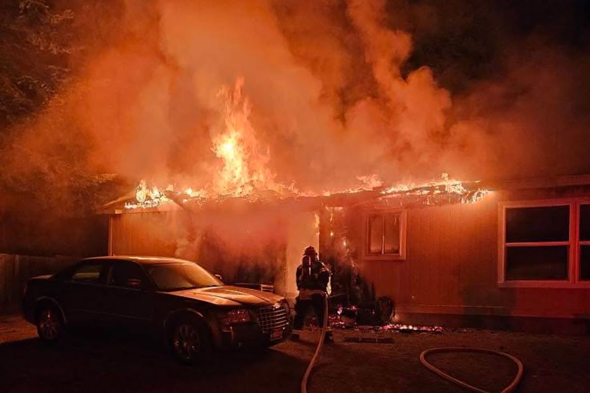 Flames engulf the home of Liz and Brent Justus. (Courtesy)