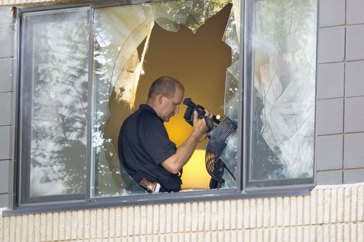 A Moscow police officer uses a video camera in a room rented by Ernesto Bustamante at the University Inn-Best Western in Moscow, Idaho, on Tuesday, Aug. 23, 2011. Bustamante is suspected of shooting and killing a 22-year-old woman in Moscow on Monday. (Geoff Crimmins / Moscow-pullman Daily News)