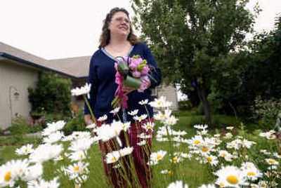 
Angela Hagedorn holds a one of a kind wedding bouquet, including peonies and veronica.
 (Brian Plonka photos/ / The Spokesman-Review)